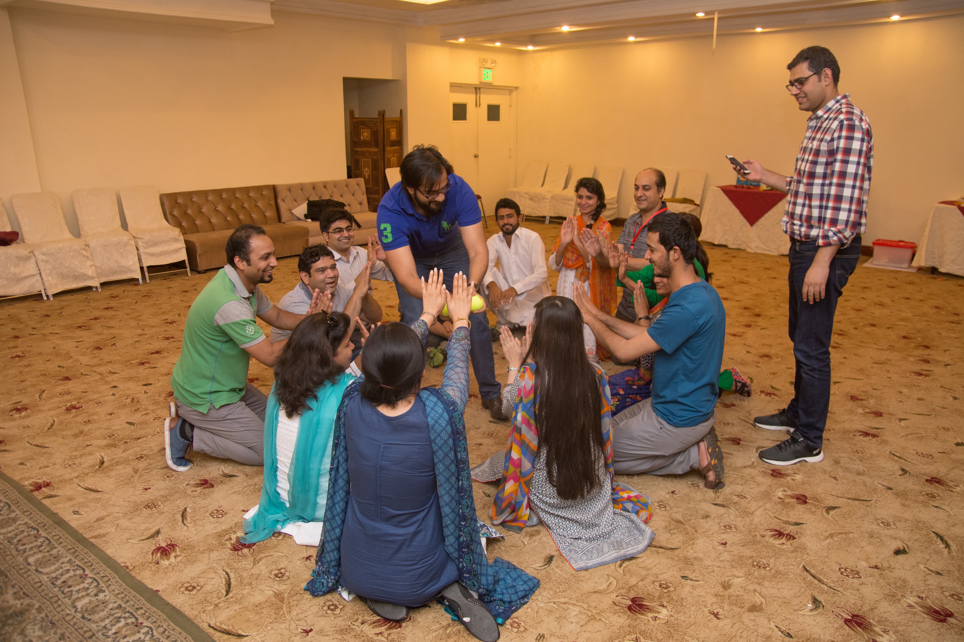 Team members sitting in a circle during a participatory community engagement activity